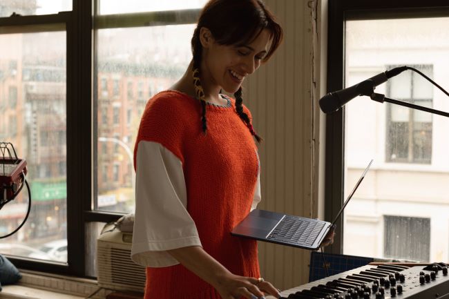 A woman making music with the M2 MacBook Air.