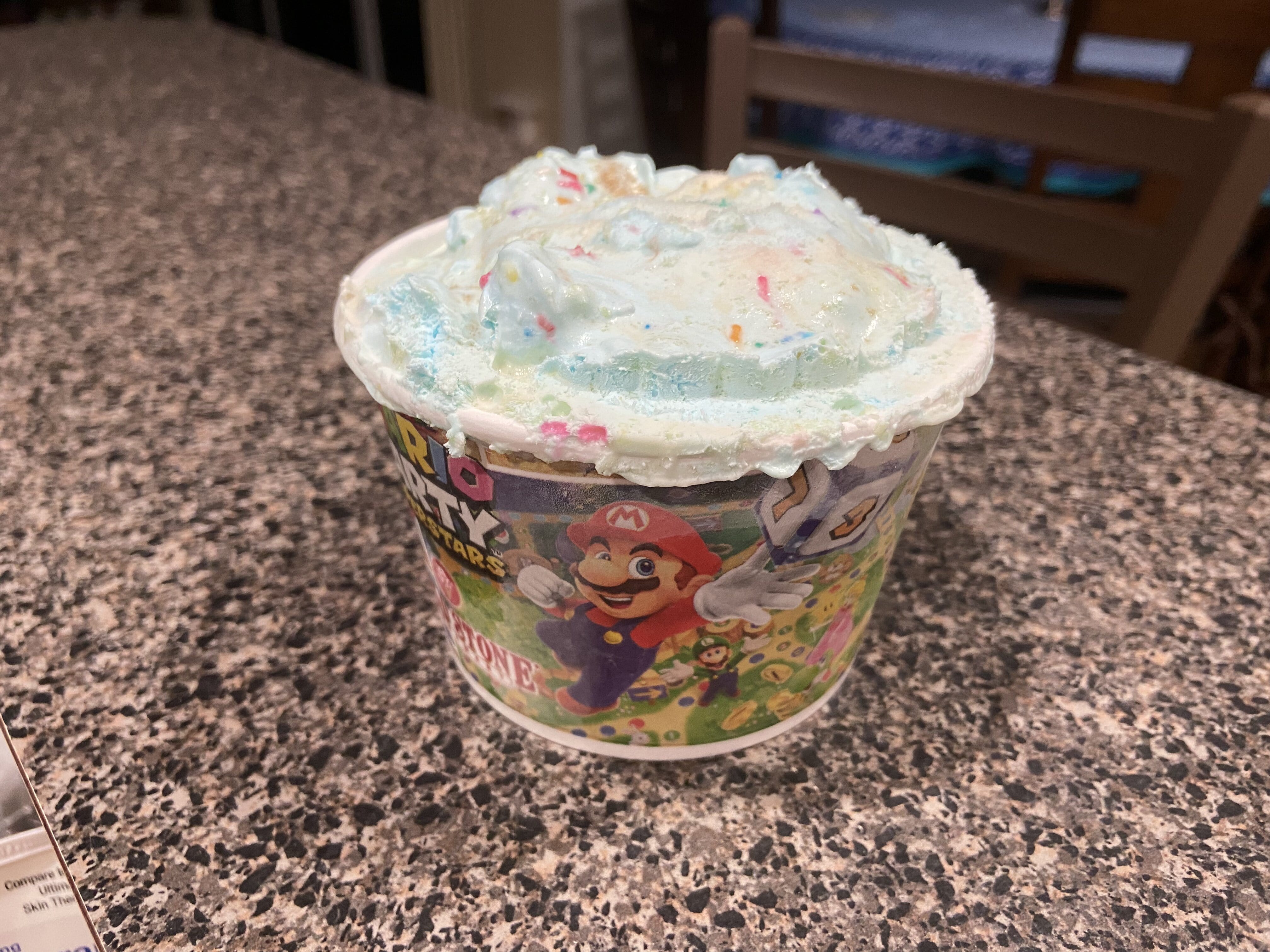 Cold Stone's Mario ice cream sits in a container.