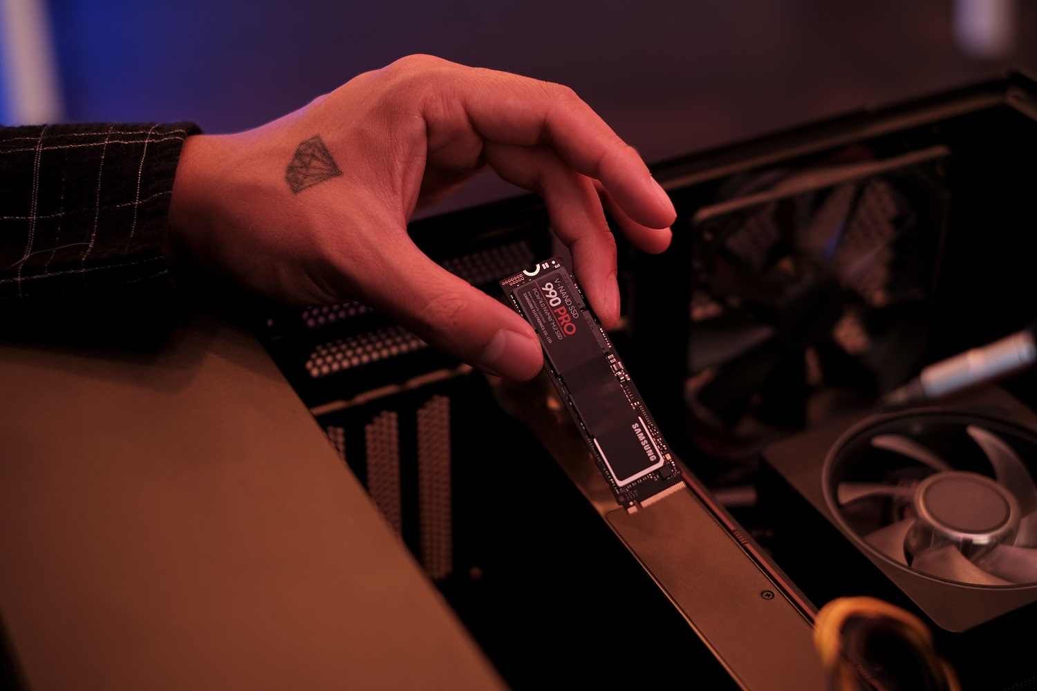 The Samsung 990 Pro SSD being installed in a PC.