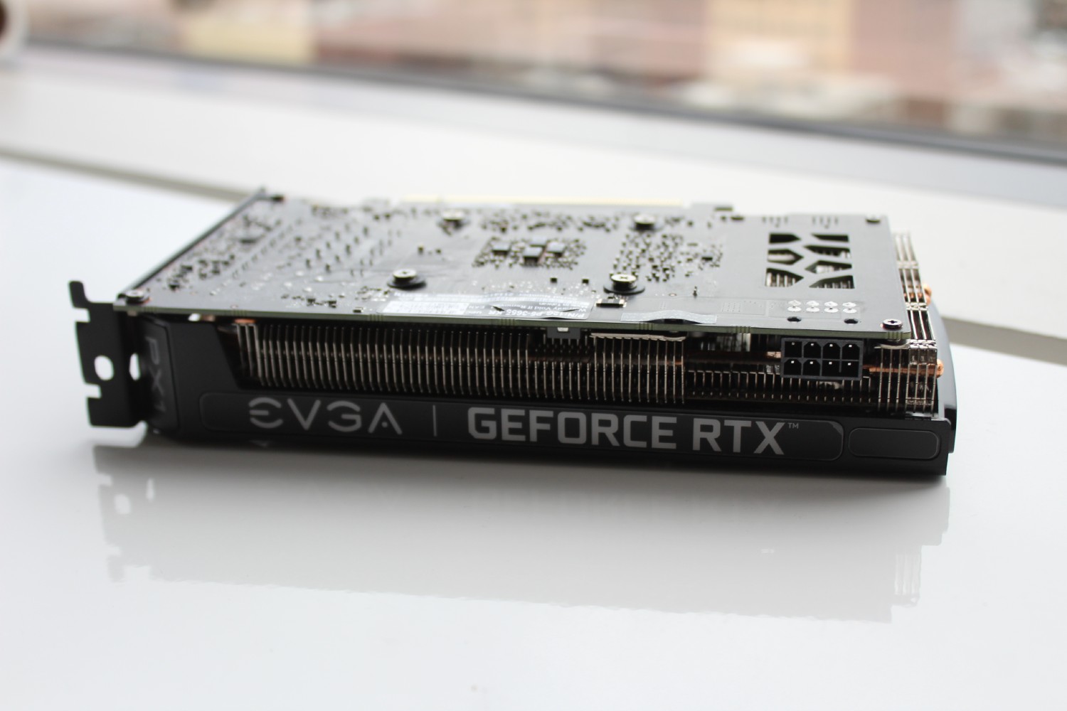 EVGA RTX 3060 graphics card laying on a table.