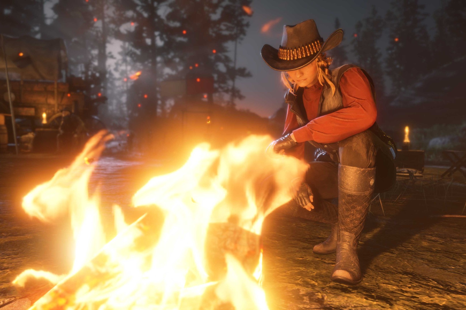A female player crafts by a fire in Red Dead Online.