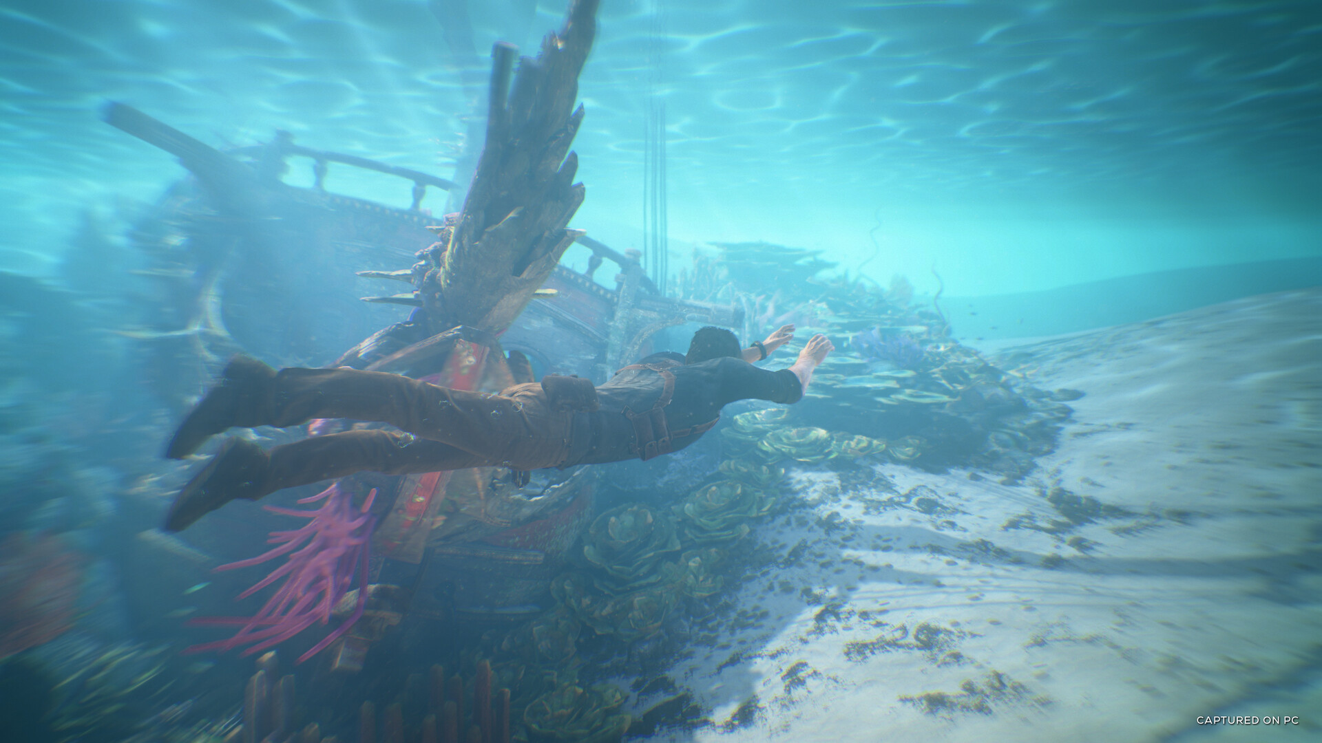 Nathan Drake swimming underwater in Uncharted 4.