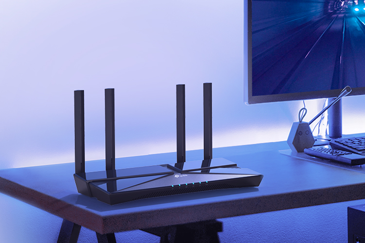 A TP Link Archer AX3000 Wi-Fi 6 router on a desk.